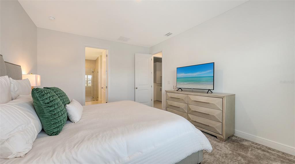 11869 Richmond Trail Parrish, FL 34219 - Photo 32 of 68 a bedroom with a bed and a flat screen tv