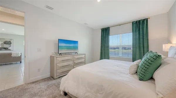 a bed room with a bed and a dresser