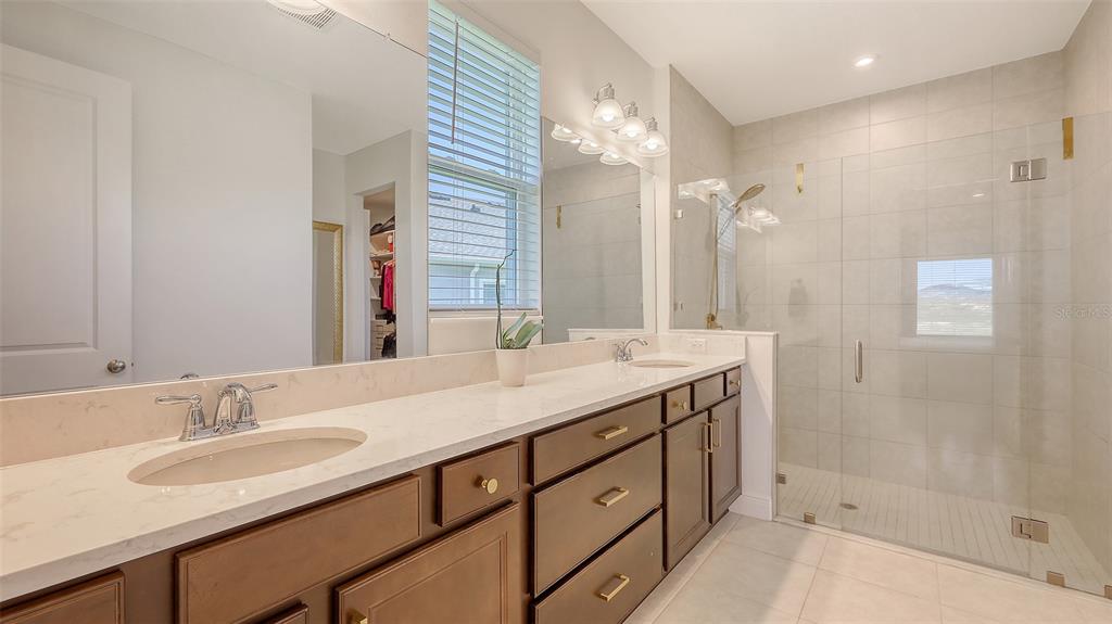 11869 Richmond Trail Parrish, FL 34219 - Photo 34 of 68 a bathroom with a granite countertop sink and a mirror