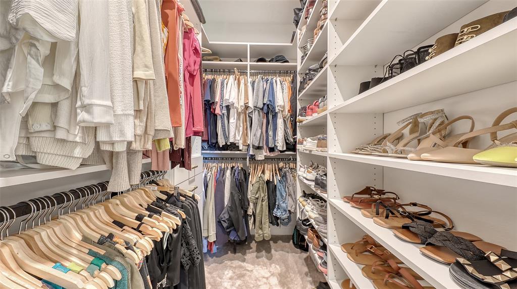 11869 Richmond Trail Parrish, FL 34219 - Photo 38 of 68 a view of walk in closet with clothes and shoes