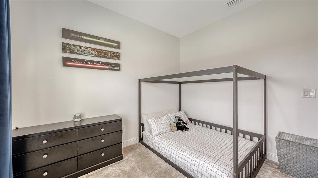 11869 Richmond Trail Parrish, FL 34219 - Photo 40 of 68 a bed room with a bed and a dresser