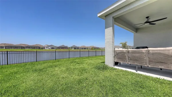 a view of a chairs and table in patio with a yard