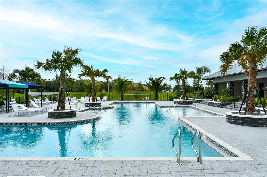 11869 Richmond Trail Parrish, FL 34219 - Photo 64 of 68 a view of a swimming pool with lounge chairs