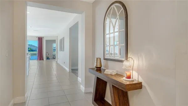 a large white kitchen with stainless steel appliances kitchen island granite countertop a sink a stove and a refrigerator