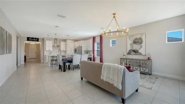 a kitchen with stainless steel appliances kitchen island granite countertop a sink a stove a refrigerator and island with wooden floor