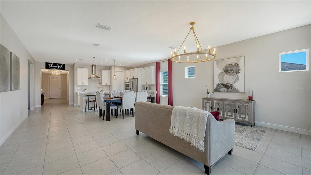 11869 Richmond Trail Parrish, FL 34219 - Photo 9 of 68 a living room with furniture and a chandelier