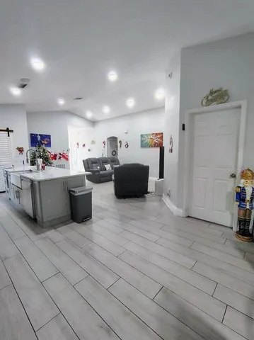 a kitchen with kitchen island a table and chairs
