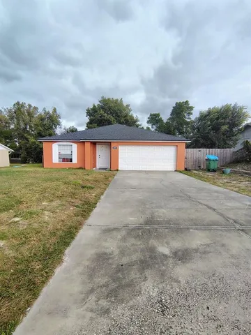 a view of house with yard and ocean view