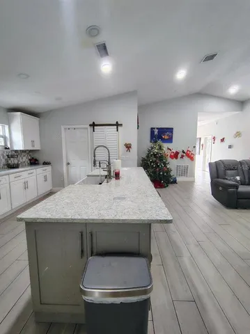 a bathroom with a granite countertop sink a toilet and a mirror