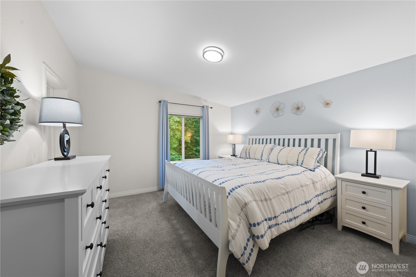 23825 15th Avenue Southeast, Unit 427 Bothell, WA 98021 - Photo 12 of 38 a bedroom with a bed and a lamp on dresser