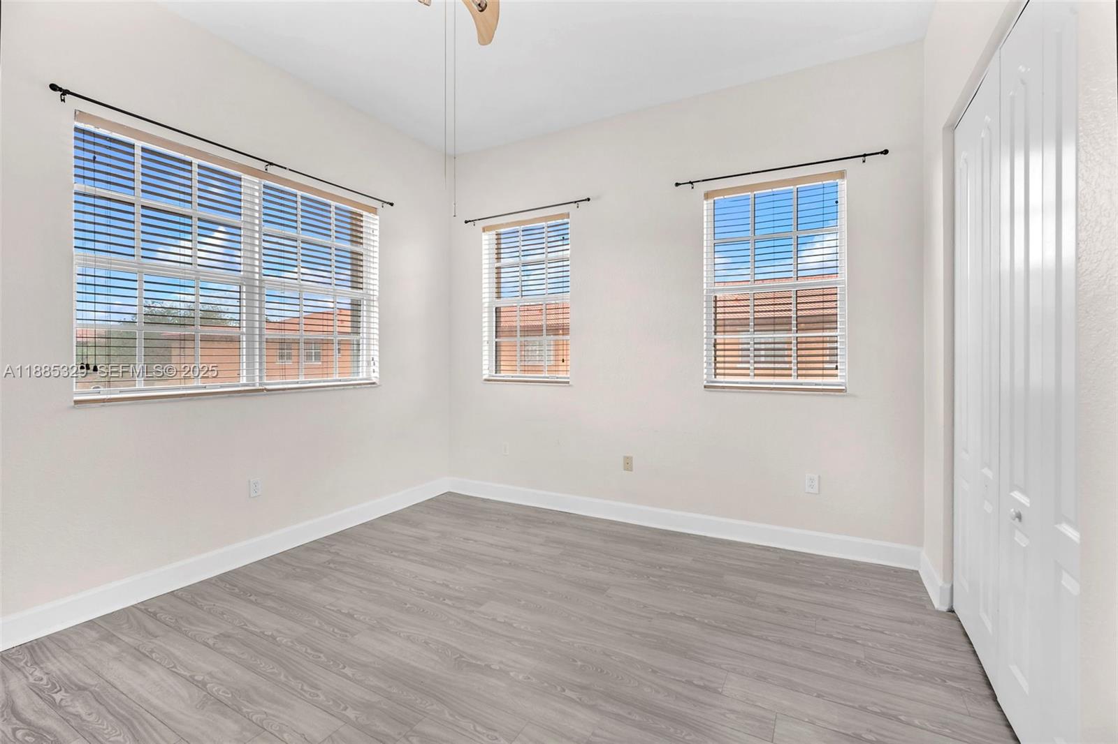 14634 Southwest 5th Street, Unit 15 Pembroke Pines, FL 33027 - Photo 21 of 56 an empty room with wooden floor and windows