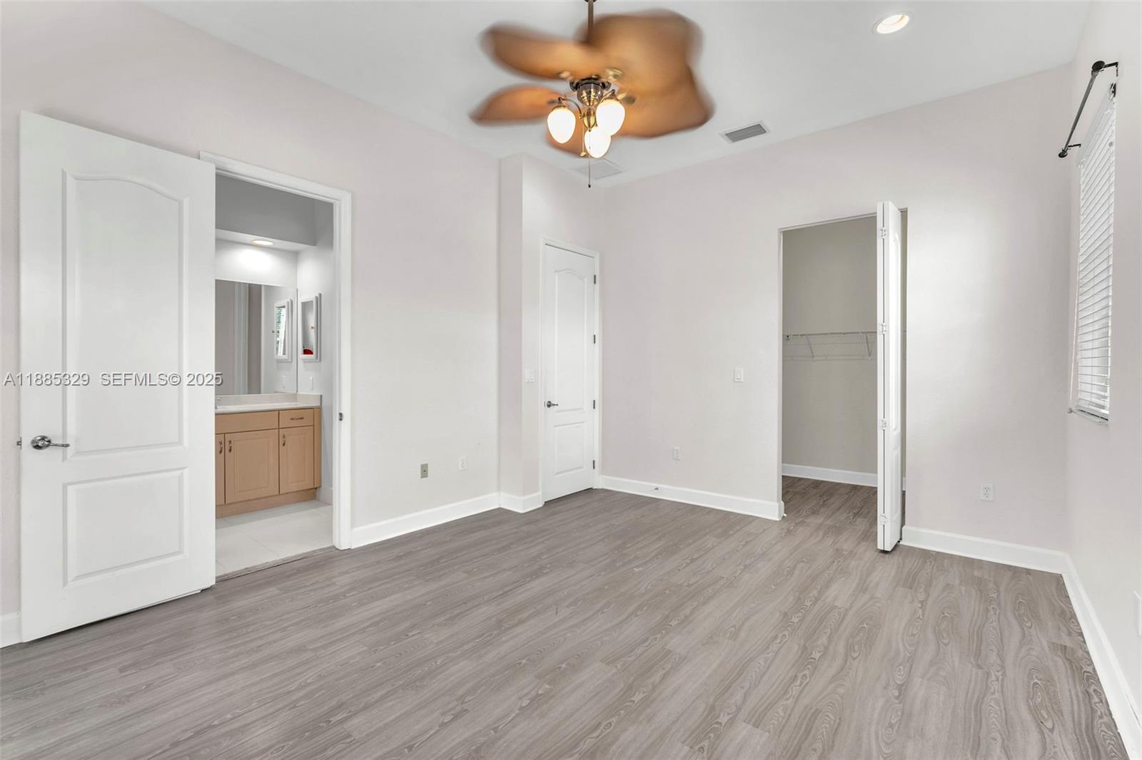 14634 Southwest 5th Street, Unit 15 Pembroke Pines, FL 33027 - Photo 25 of 56 wooden floor in an empty room with a window