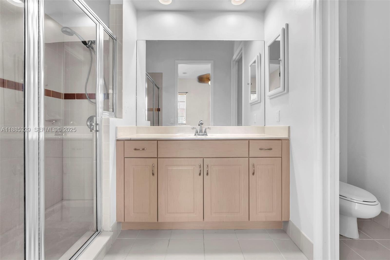 14634 Southwest 5th Street, Unit 15 Pembroke Pines, FL 33027 - Photo 26 of 56 a bathroom with a sink and a mirror