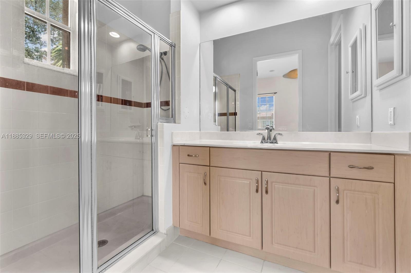 14634 Southwest 5th Street, Unit 15 Pembroke Pines, FL 33027 - Photo 27 of 56 a bathroom with a shower sink and mirror