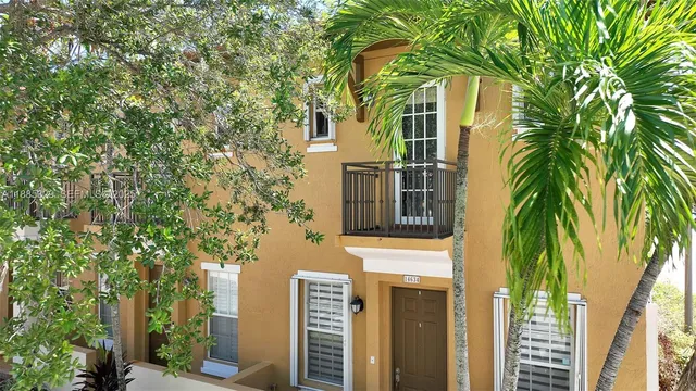 an aerial view of a house with garden space and ocean view