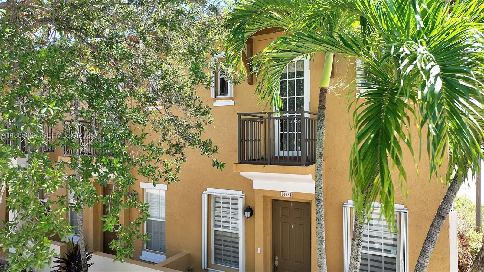 14634 Southwest 5th Street, Unit 15 Pembroke Pines, FL 33027 - Photo 33 of 56 a front view of a house with a tree
