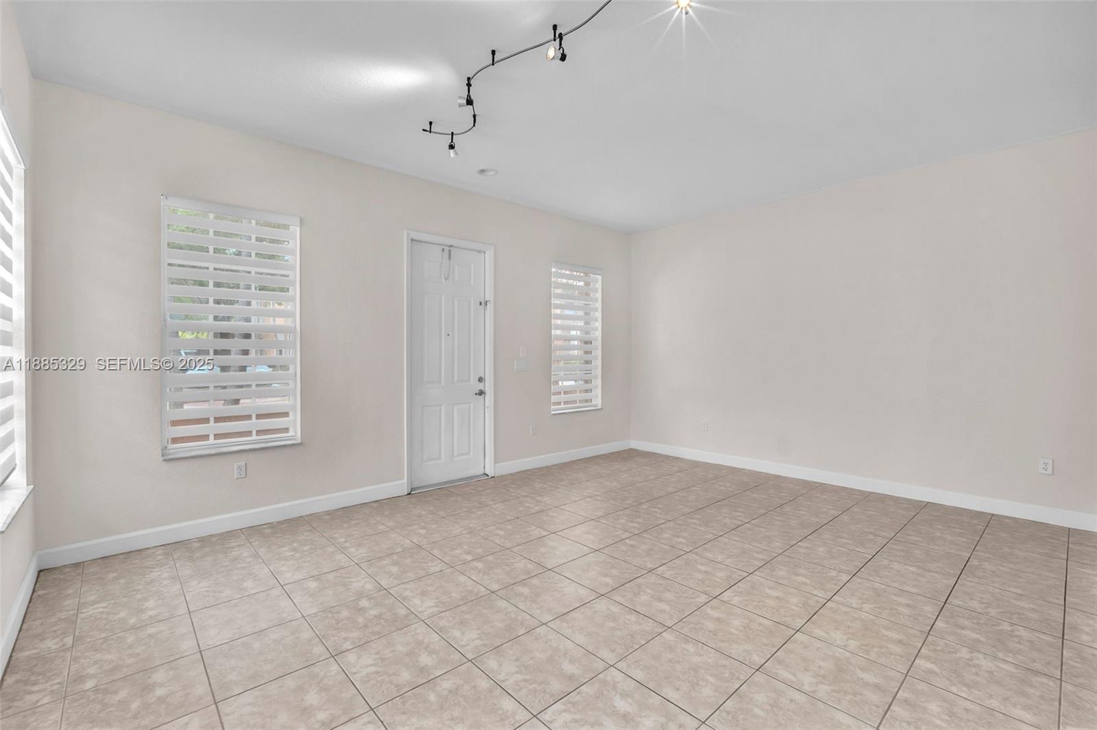 14634 Southwest 5th Street, Unit 15 Pembroke Pines, FL 33027 - Photo 7 of 56 an empty room with windows