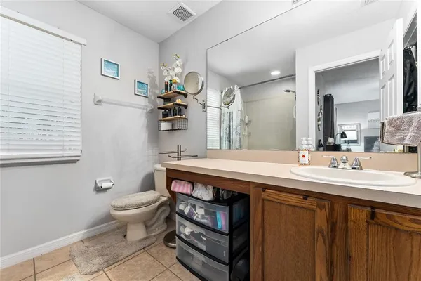 a bathroom with a sink a toilet and mirror