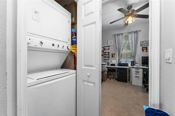 a view of washer and dryer with kitchen in the background