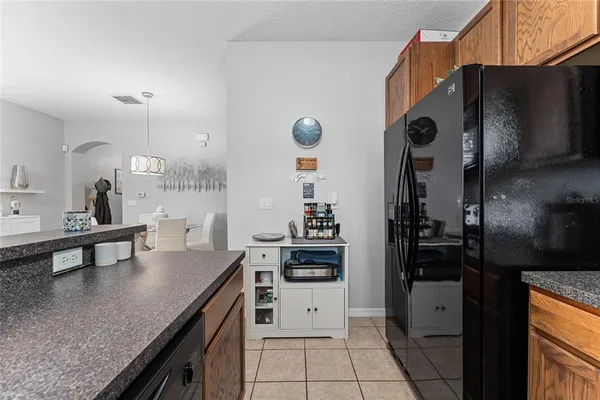 a kitchen with granite countertop a sink a stove and refrigerator