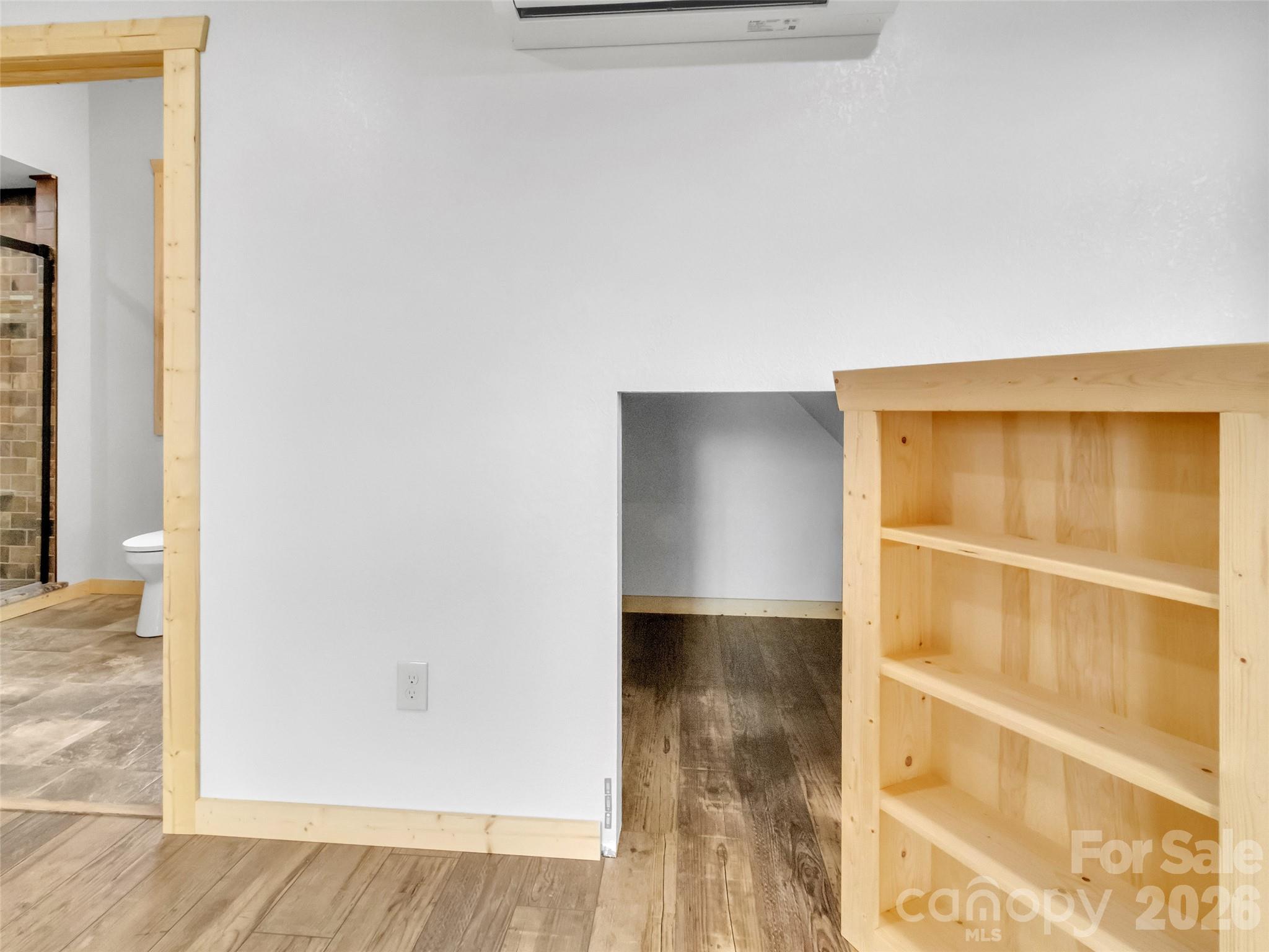171 Cowtail Cove Clyde, NC 28721 - Photo 29 of 48 a view of an empty room with wooden floor and a window