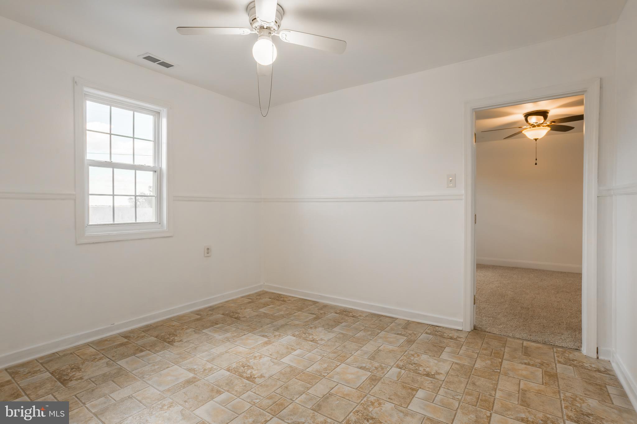 8952 Cannon Road Bridgeville, DE 19933 - Photo 11 of 29 an empty room with windows and fan