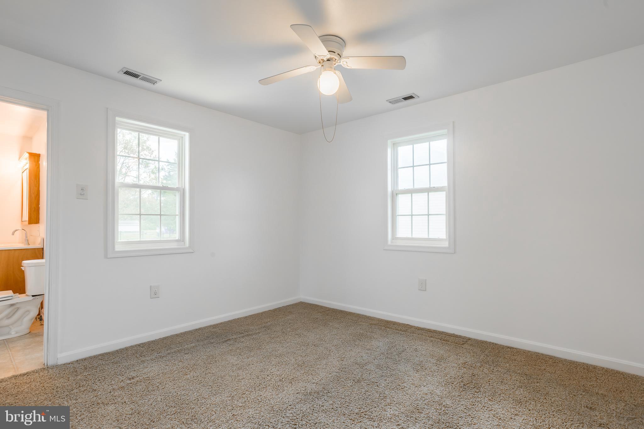 8952 Cannon Road Bridgeville, DE 19933 - Photo 15 of 29 an empty room with windows and ceiling fan