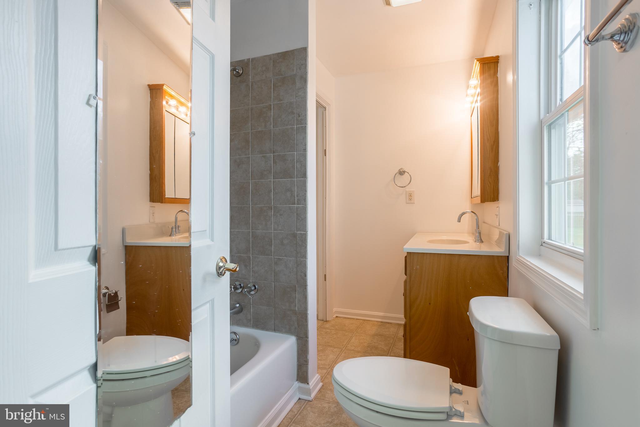 8952 Cannon Road Bridgeville, DE 19933 - Photo 16 of 29 a white toilet sitting next to a bathroom sink