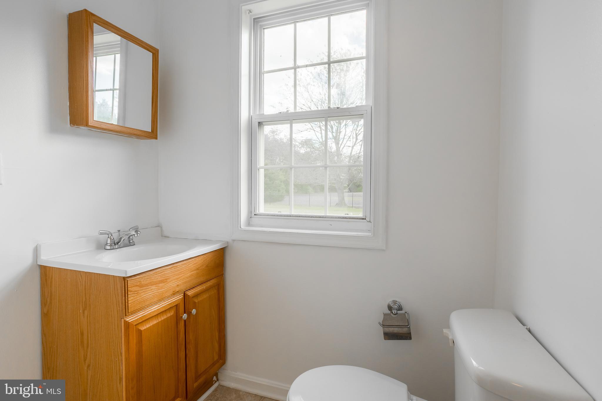 8952 Cannon Road Bridgeville, DE 19933 - Photo 19 of 29 a bathroom with a sink a toilet and a window