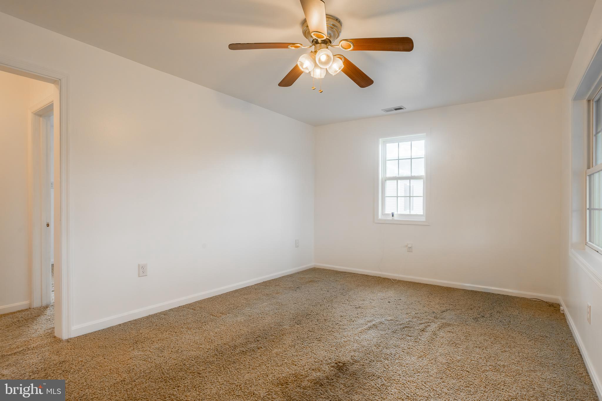 8952 Cannon Road Bridgeville, DE 19933 - Photo 7 of 29 an empty room with a window and a fan