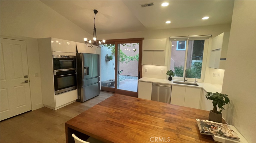 15 Marsala Irvine, CA 92606 - Photo 12 of 31 a kitchen with sink refrigerator and microwave