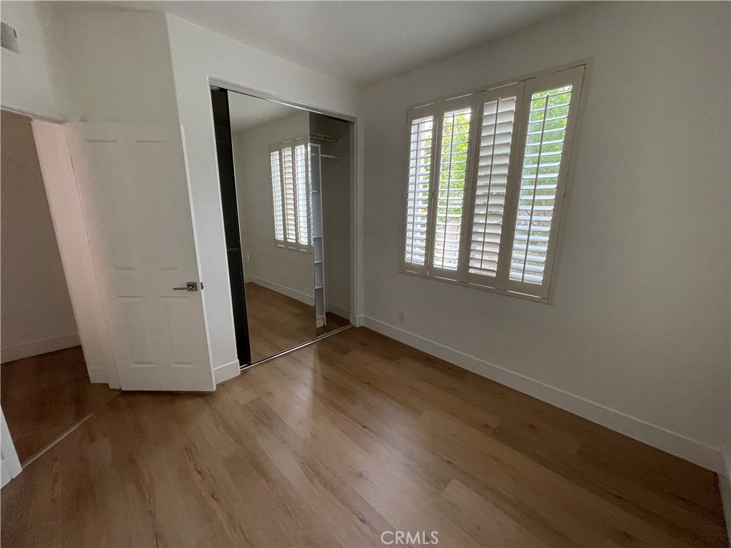 15 Marsala Irvine, CA 92606 - Photo 18 of 31 an empty room with wooden floor and windows