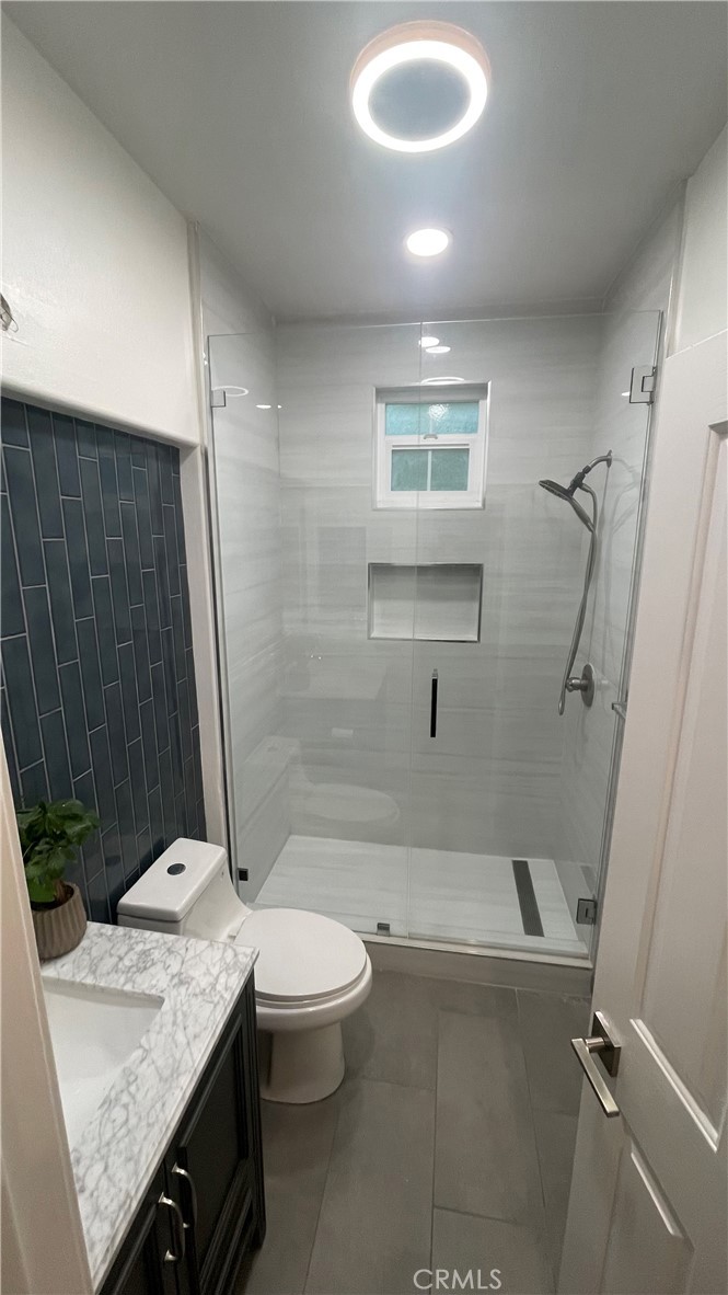 15 Marsala Irvine, CA 92606 - Photo 20 of 31 a bathroom with a granite countertop sink toilet and shower