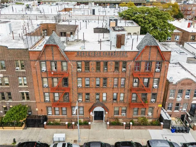 a front view of a residential apartment building with a yard