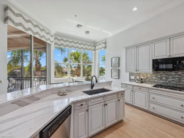a kitchen with stainless steel appliances granite countertop a sink and cabinets
