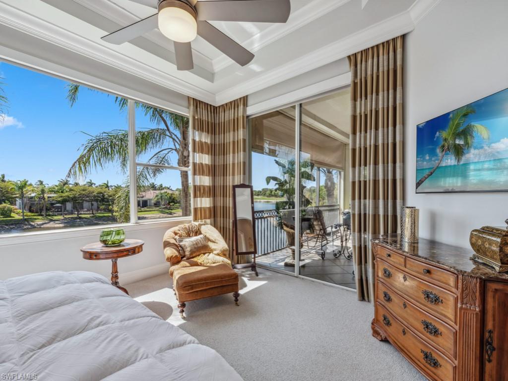 16985 Porta Vecchio Way, Unit 202 Naples, FL 34110 - Photo 18 of 50 a living room with furniture and a large window