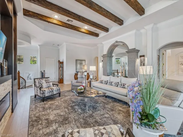 a living room with furniture and flowers