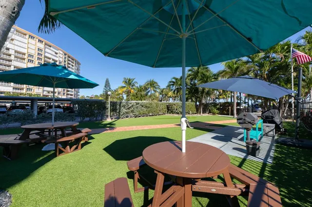 a patio with a table and chairs under an umbrella