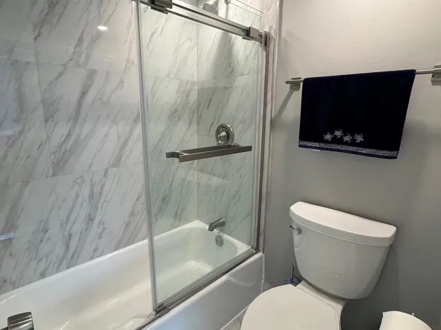 a bathroom with a toilet a sink and bathtub