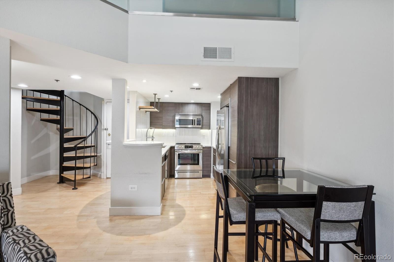 350 Detroit Street, Unit 413 Denver, CO 80206 - Photo 11 of 24 a dining room with furniture and wooden floor