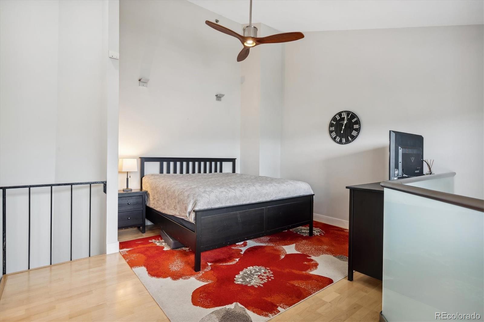 350 Detroit Street, Unit 413 Denver, CO 80206 - Photo 13 of 24 a bedroom with a bed and a table in it