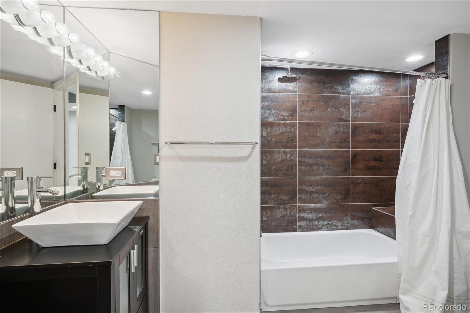 350 Detroit Street, Unit 413 Denver, CO 80206 - Photo 15 of 24 a bathroom with a sink and a mirror
