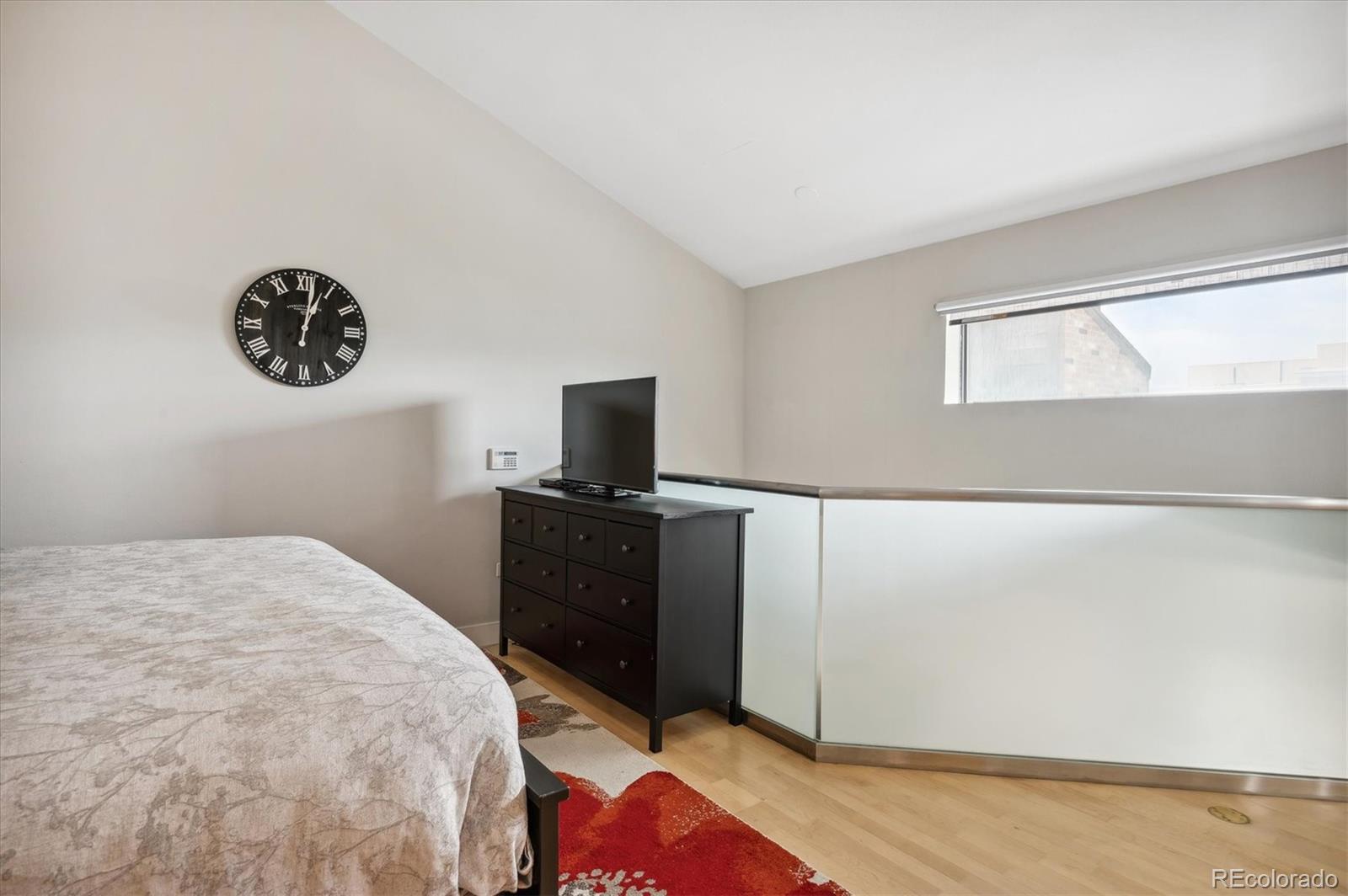 350 Detroit Street, Unit 413 Denver, CO 80206 - Photo 17 of 24 a bedroom with a bed and a television