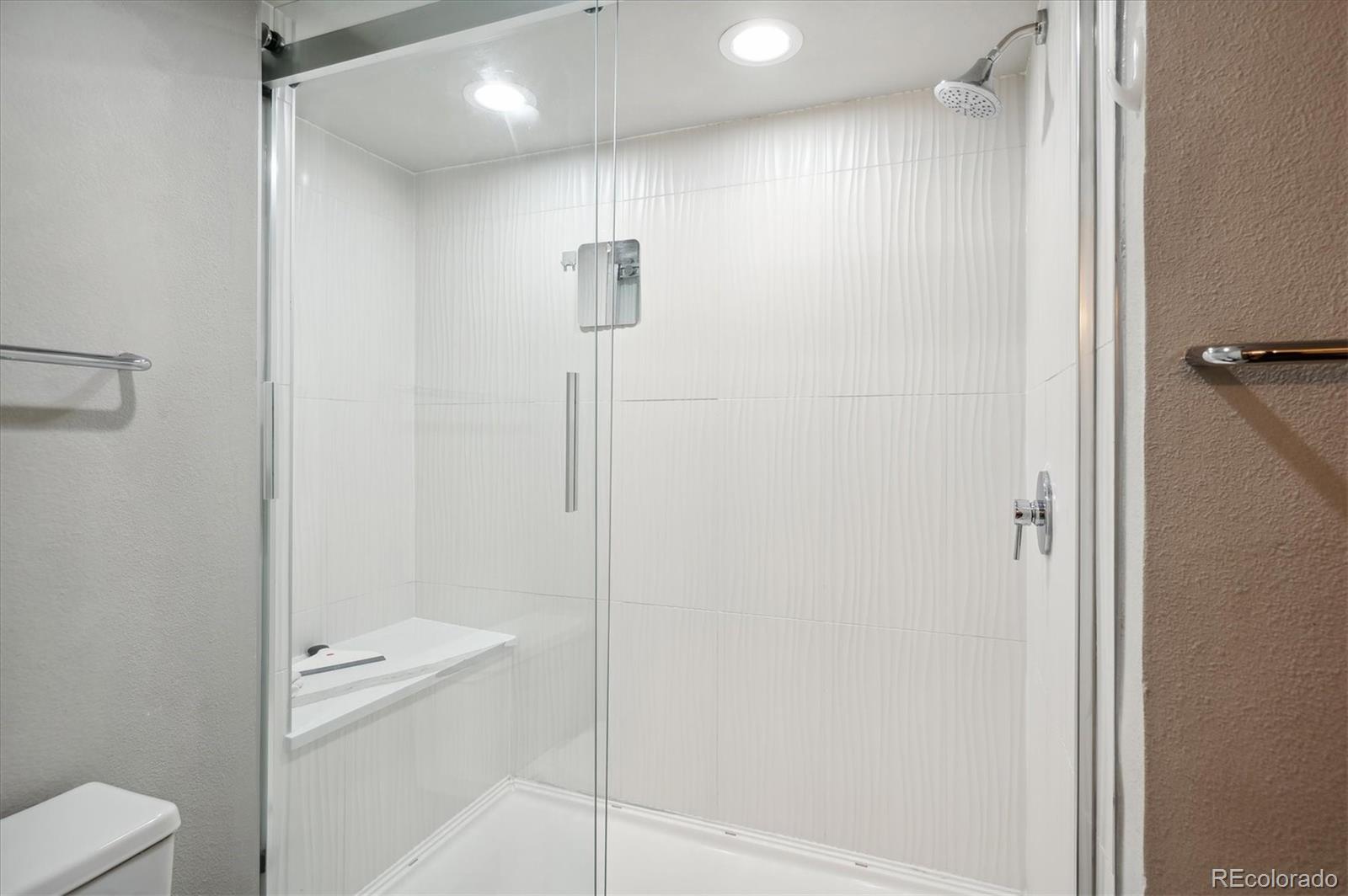 350 Detroit Street, Unit 413 Denver, CO 80206 - Photo 20 of 24 a bathroom with a shower a toilet and sink