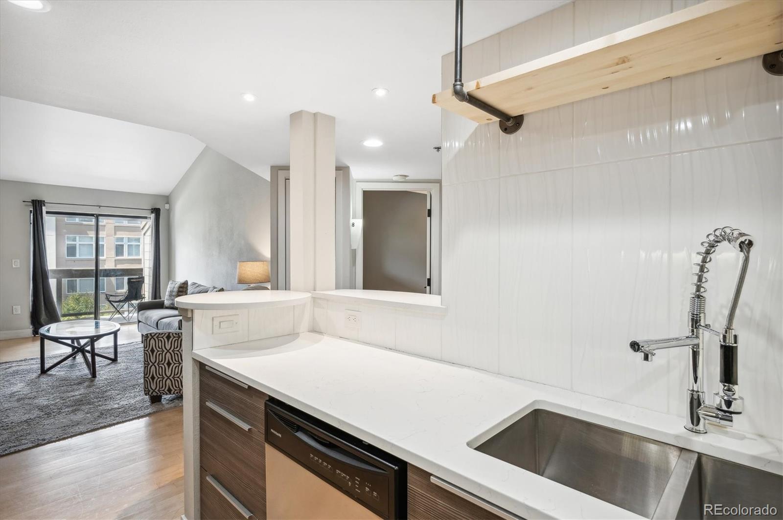 350 Detroit Street, Unit 413 Denver, CO 80206 - Photo 8 of 24 a kitchen with a sink appliances and a counter top space