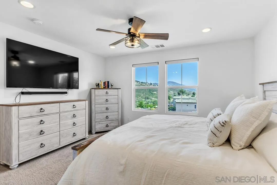 2811 Safflower Street Spring Valley, CA 91977 - Photo 17 of 28 a spacious bedroom with a bed and a flat screen tv