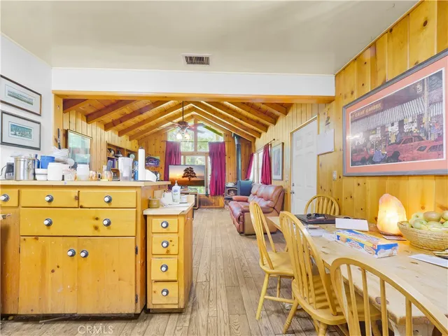 a view of a dining room with furniture a chandelier and wooden floor