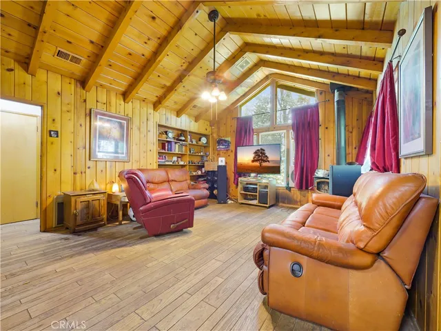 a living room with furniture a couch and large windows