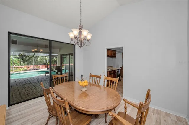 a view of a dining room with furniture wooden floor and chandelier
