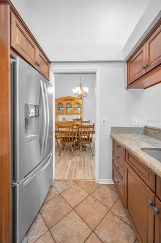 a kitchen with a refrigerator and a sink